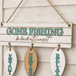“Gone Fishing – Be Back at Sunset” wooden hanging sign.