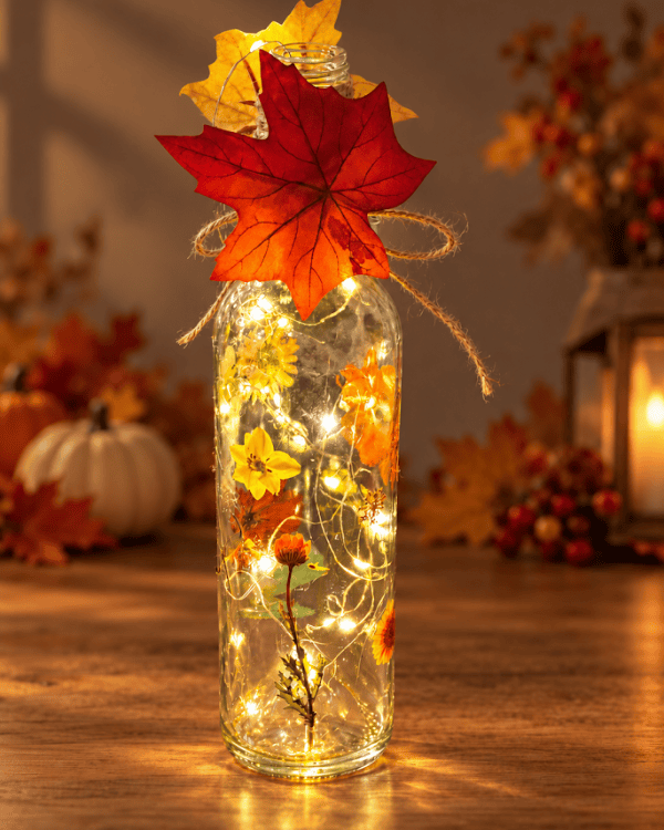 Lighted Fall Bottle Decor with Flowers and Autumn Leaves